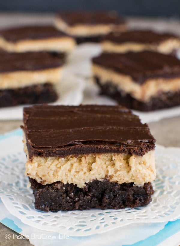Peanut Butter Truffle Brownies - chocolate and peanut butter layers make these easy brownies taste amazing. Awesome dessert recipe to make for parties! #brownies #peanutbutter #chocolate #recipe #bestdessert