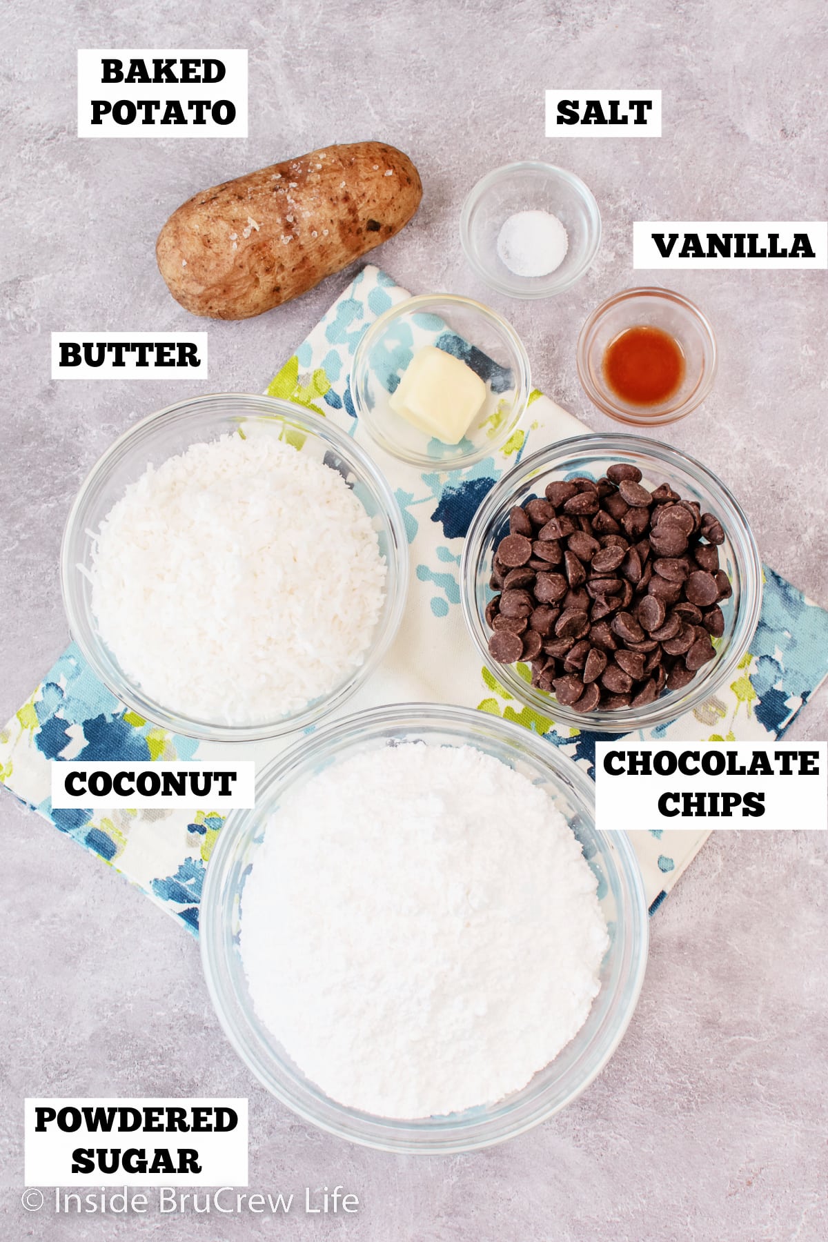 A gray board with bowls of ingredients needed to make mashed potato fudge.