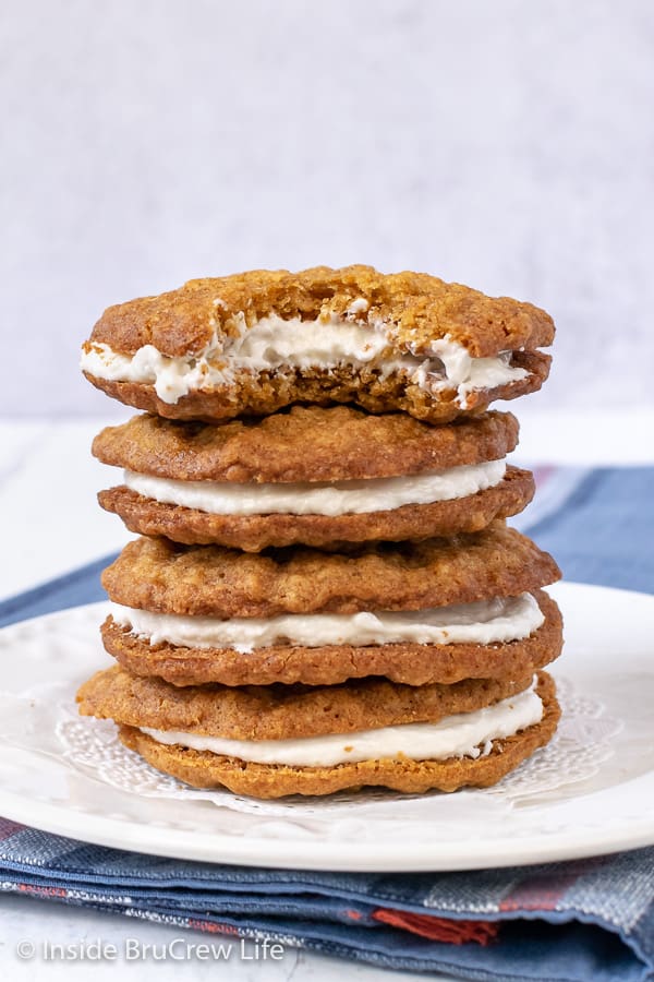 A stack of oatmeal creme pies with marshmallow filling stacked on a white plate.