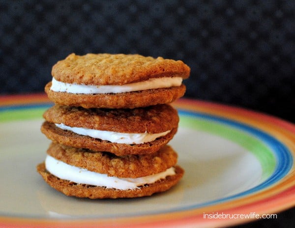 Three oatmeal creme pies on a colorful plate.