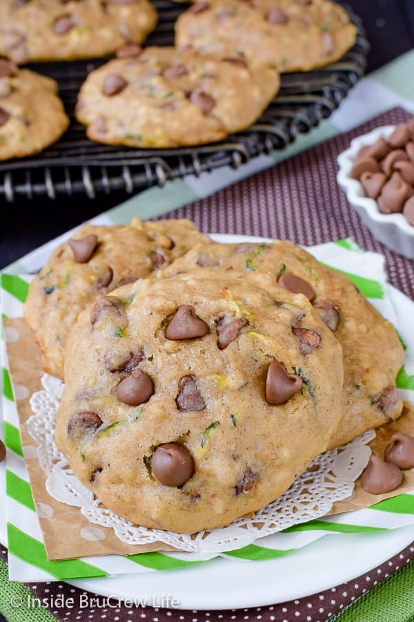 a white plate with chocolate chip zucchini cookies on it.