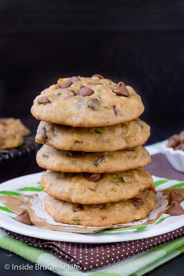 A stack of five banana chocolate chip zucchini cookies on a white plate.