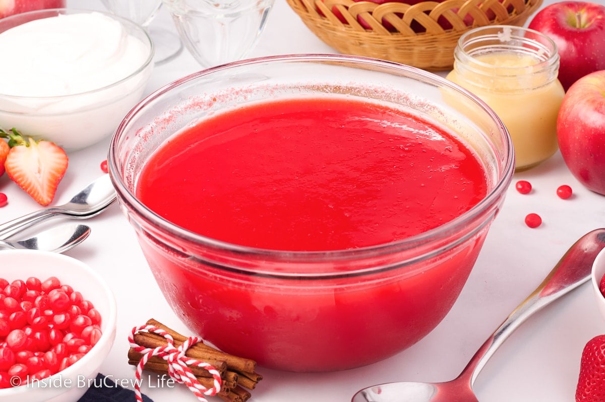 A glass bowl filled with red Jello.