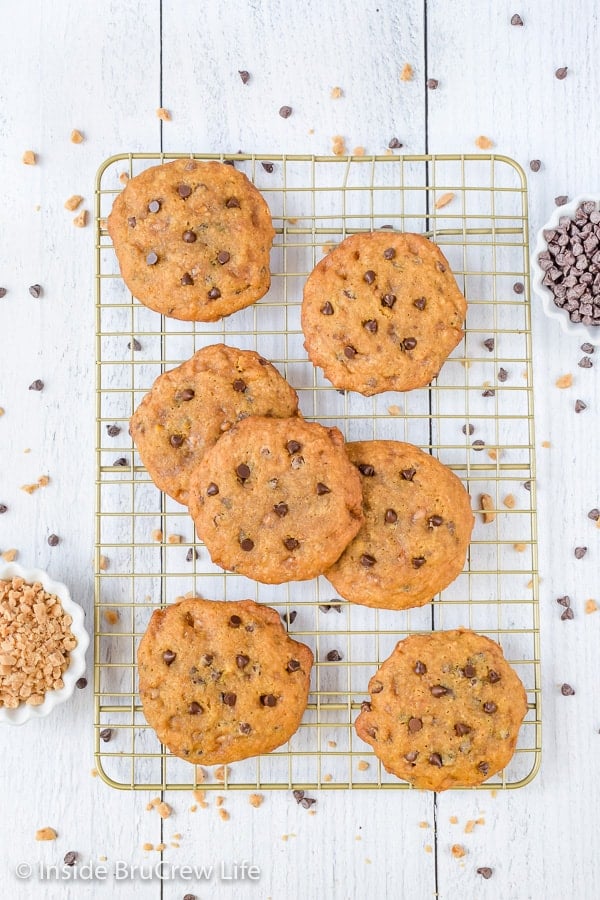 A wire rack with banoffee chocolate chip cookies stacked on it