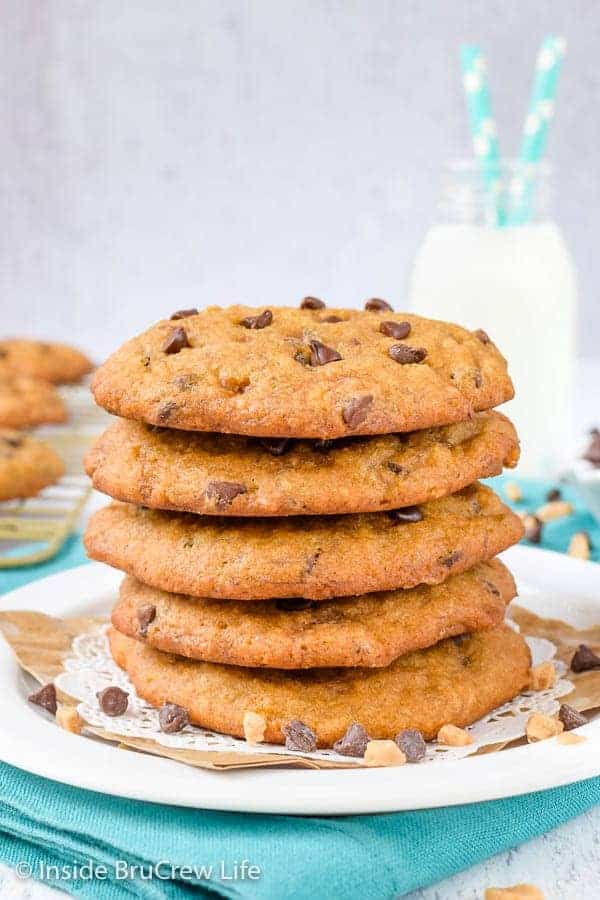 Four banoffee chocolate chip cookies stacked on a white plate