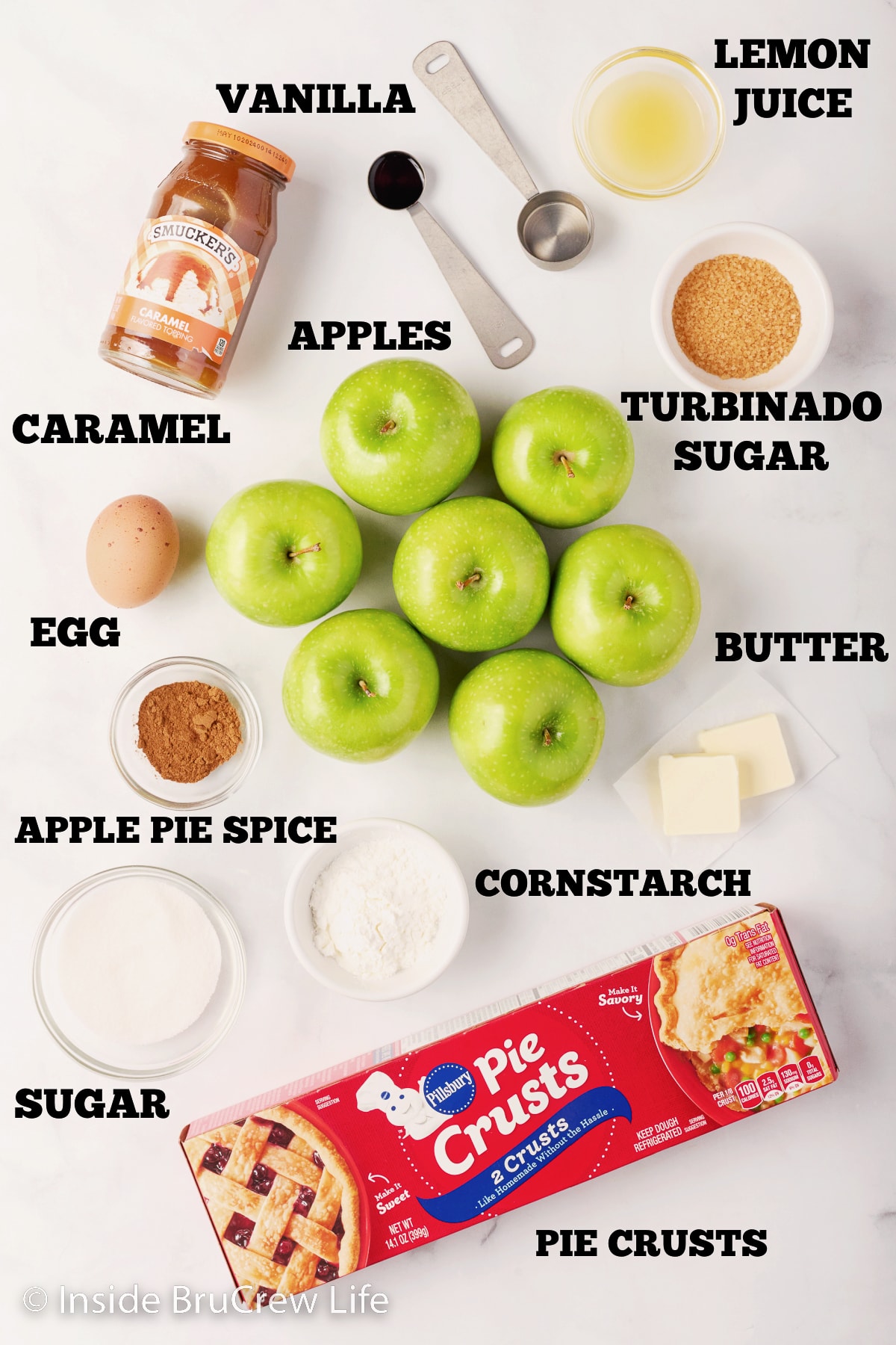 A white board with bowls of ingredients needed to make a pie.