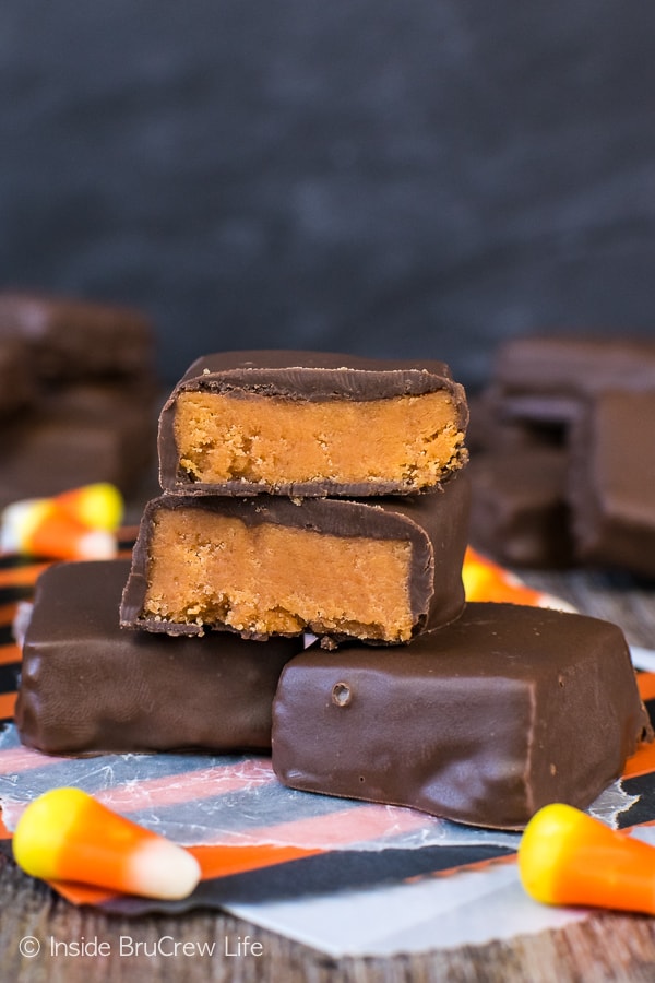 A brown board with pieces of homemade butterfinger bars and candy corn on it.