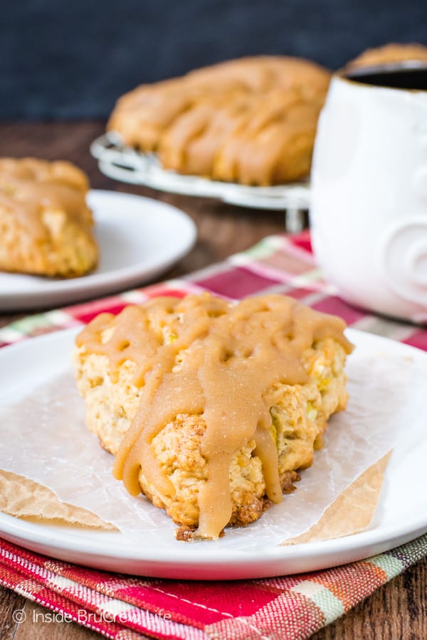 Caramel Apple Scones on a white plate with more scones behind it