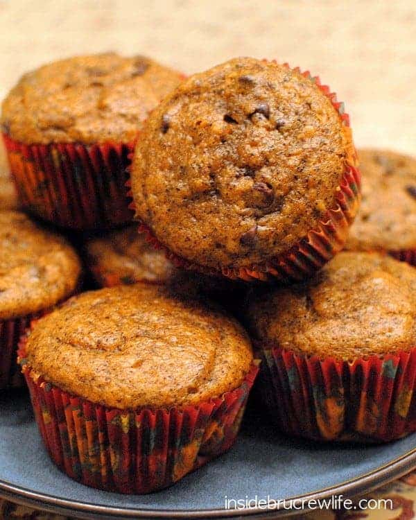 Pumpkin muffins stacked on a plate.