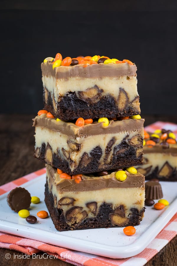 Ultimate Reese's Cheesecake Brownies - lots of Reese's candies and plenty of chocolate and peanut butter turn these into the best brownies ever! Try a pan and watch everyone devour them! #cheesecake #brownies #peanutbutter #reesespeanutbuttercups #reesesdessert #cheesecakebrownies #recipe