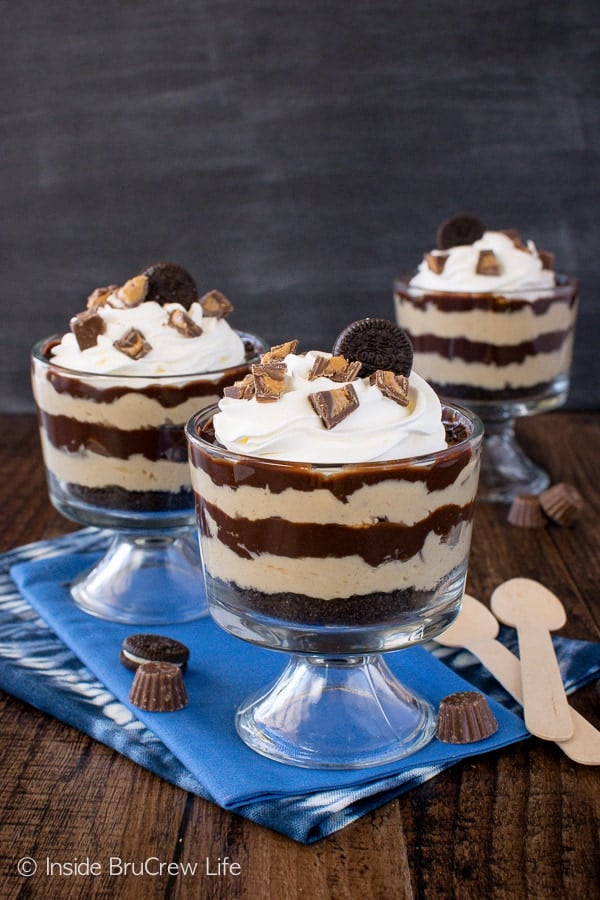 Three cups filled with chocolate and peanut butter layers.