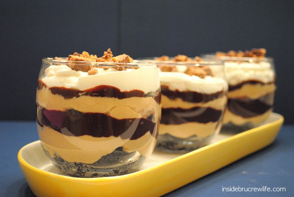 Glass jars filled with peanut butter and chocolate layers.