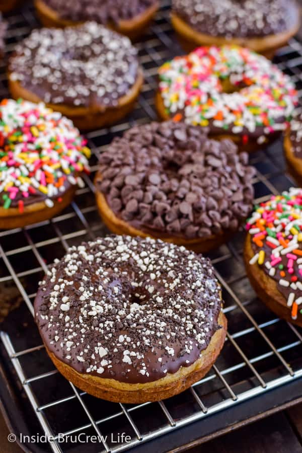 Sour Cream Banana Donuts - chocolate dipped banana donuts make the best kind of breakfast or afternoon snack! Easy recipe to make with extra ripe bananas. #banana #donuts #chocolate #bakeddonuts