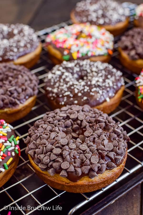 Sour Cream Banana Donuts - these soft and delicious baked donuts get a fun and crunchy flair from the chocolate coating! Great recipe to make for breakfast or an afternoon snack! #banana #donuts #chocolate #bakeddonuts