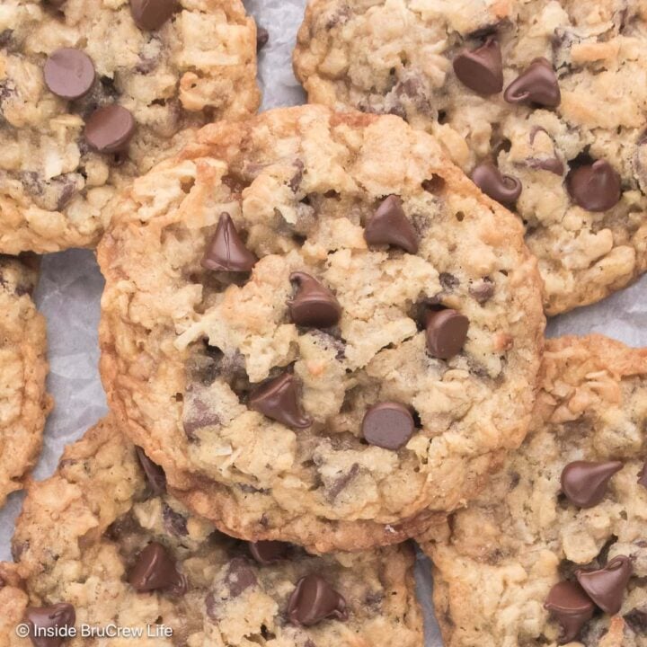 Oatmeal coconut cookies stacked on a metal pan.