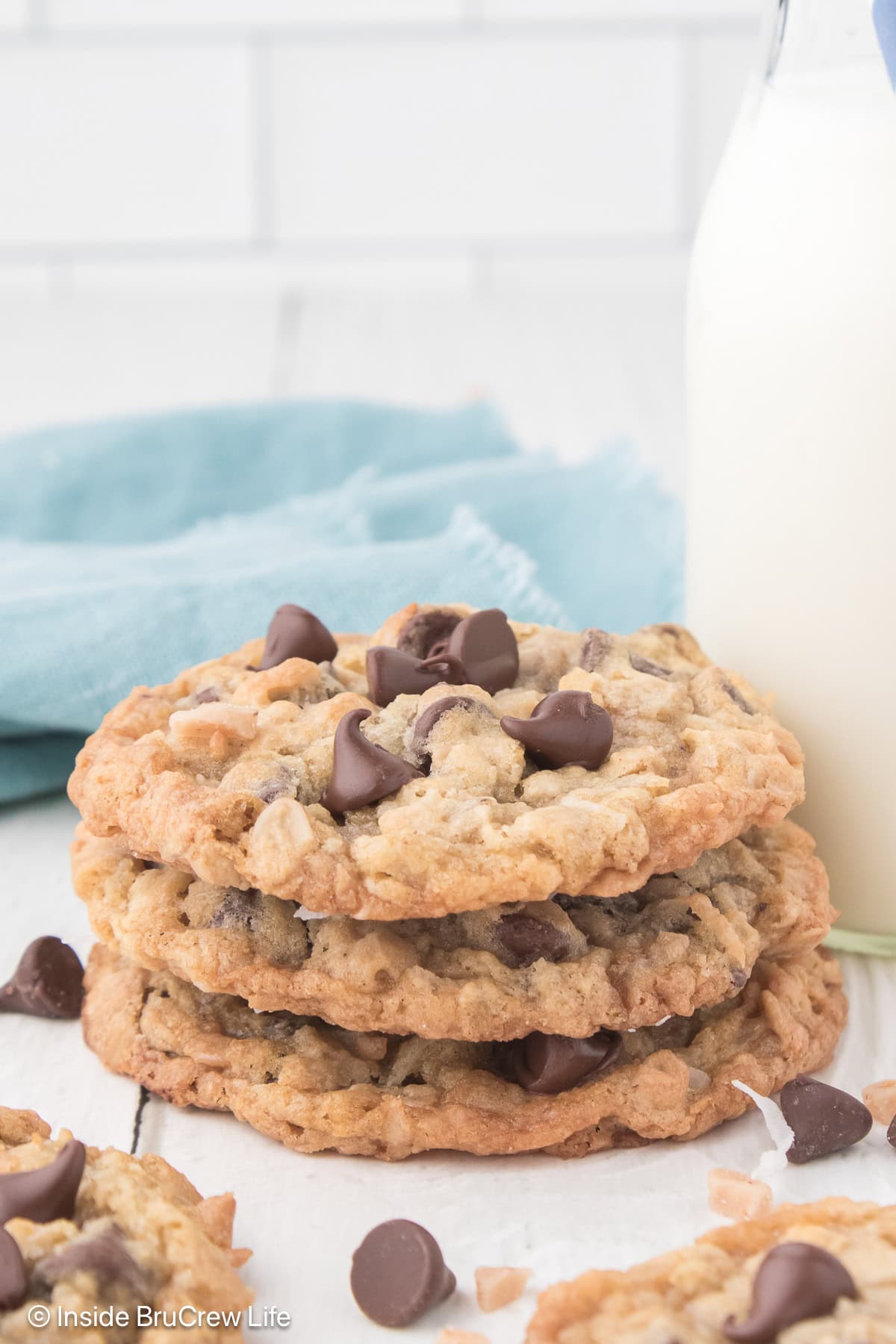 A stack of three oatmeal coconut chip cookies.