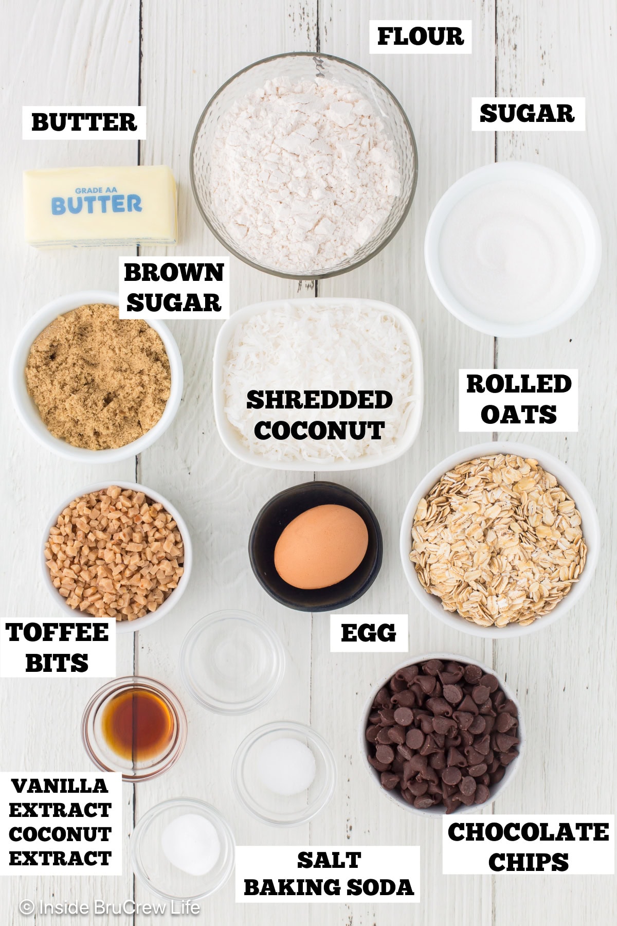 A white board with ingredients needed to make chocolate chip cookies with coconut.