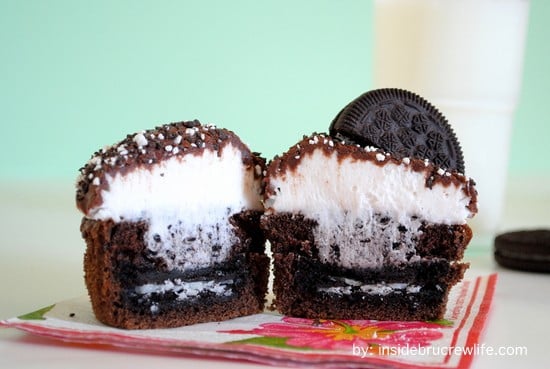 One cookies and cream cupcake cut in half showing the hidden Oreo cookie in the bottom