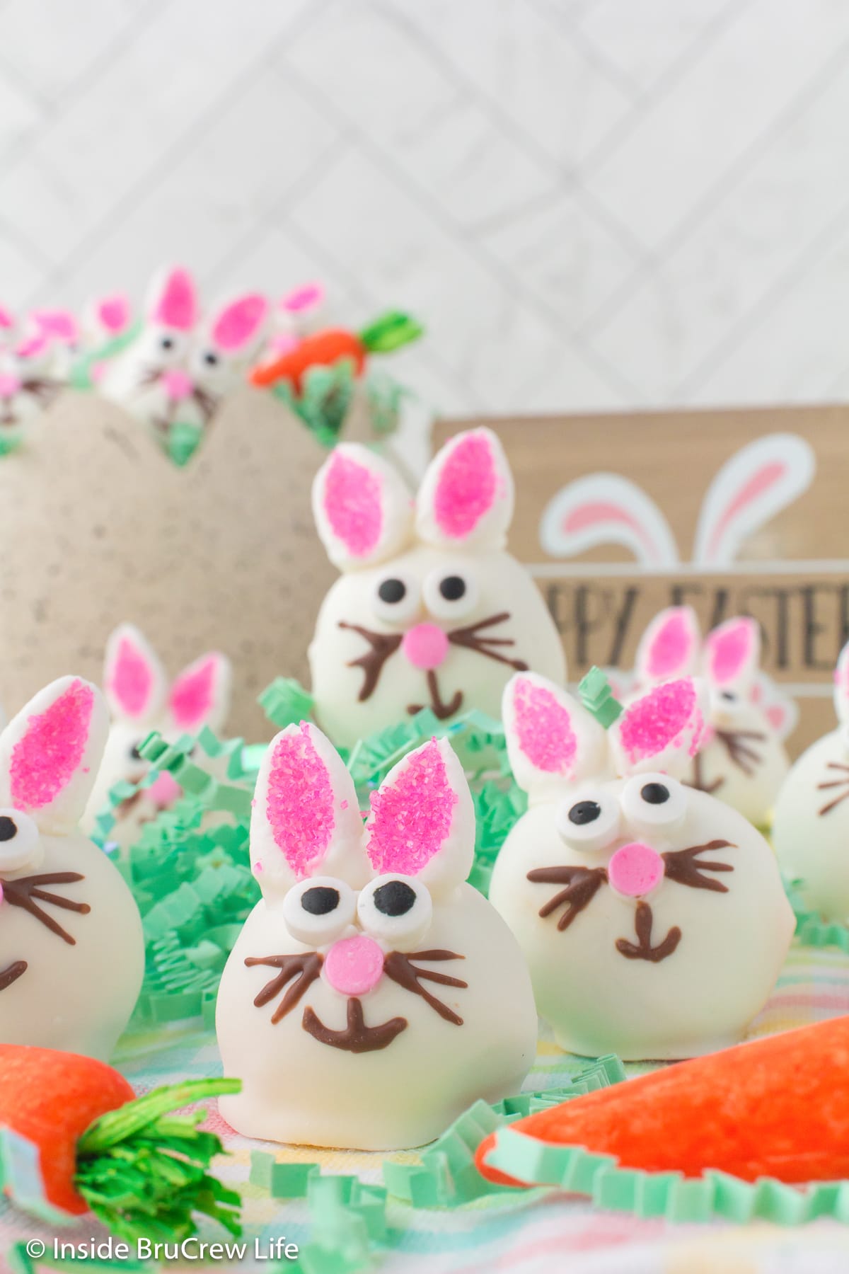 Little Easter bunnies with edible eyes and marshmallow ears on a platter.