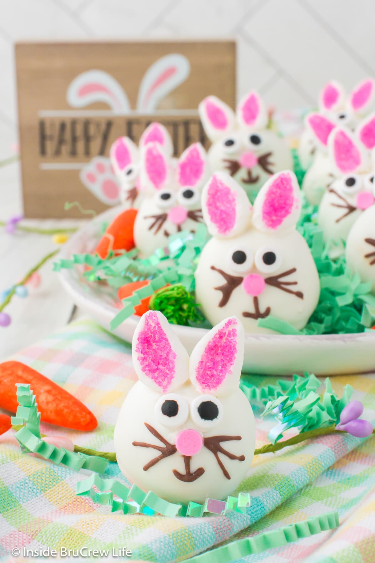 Little Easter bunnies with edible eyes and marshmallow ears on a platter.