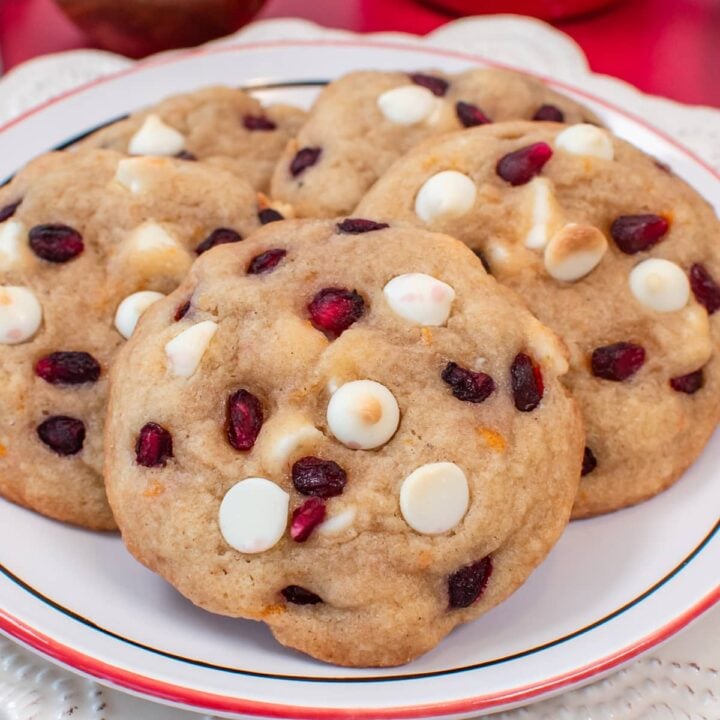A pile of cookies on a white plate.