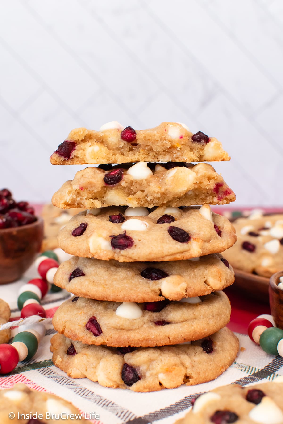A stack of white chocolate chip cookies on a plate.
