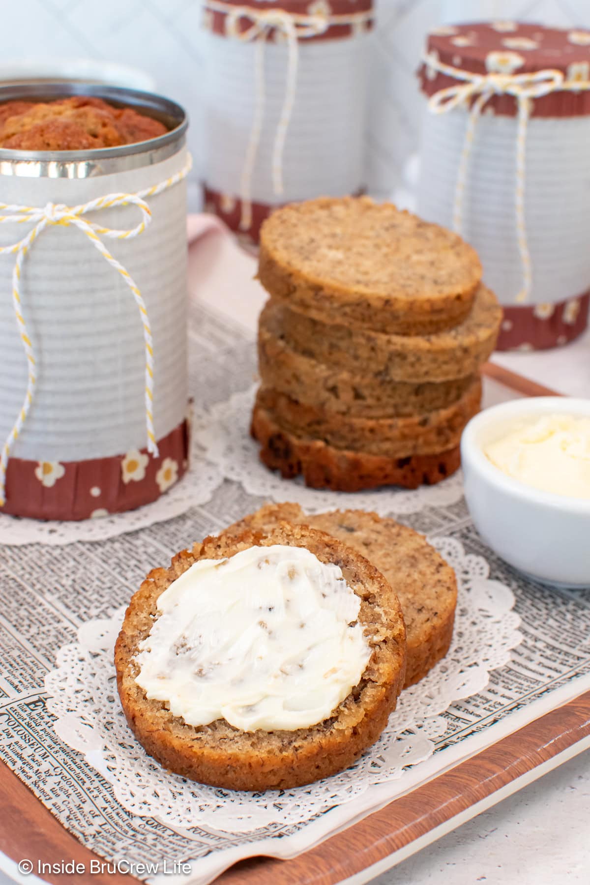 Banana bread in a can sliced and laying on a tray.