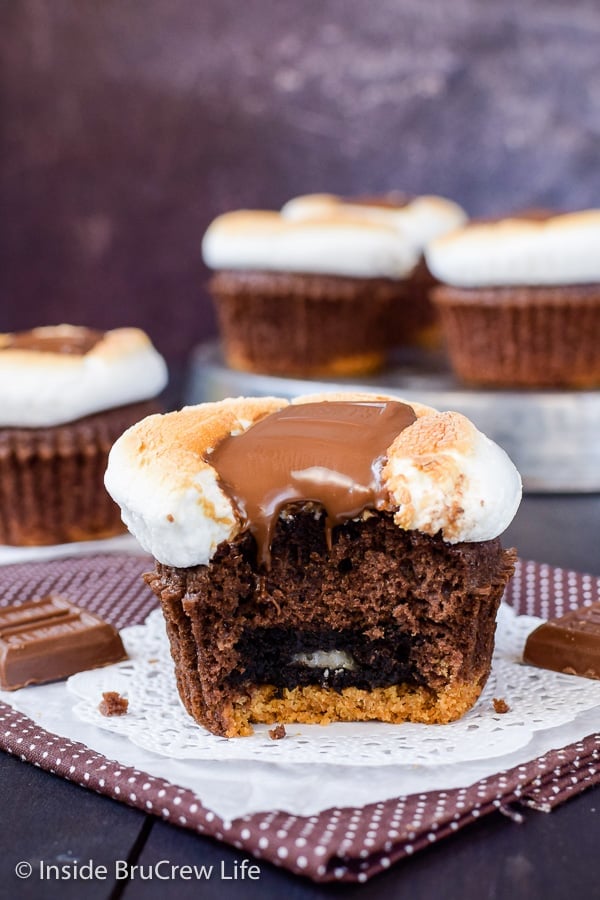A brownie cupcake with an Oreo on the bottom and a toasted marshmallow and melted candy bar on top.