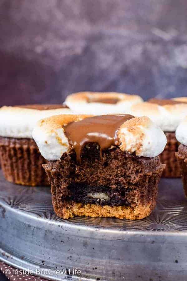 A brownie cupcake made with an Oreo on the bottom and a melted marshmallow on top.