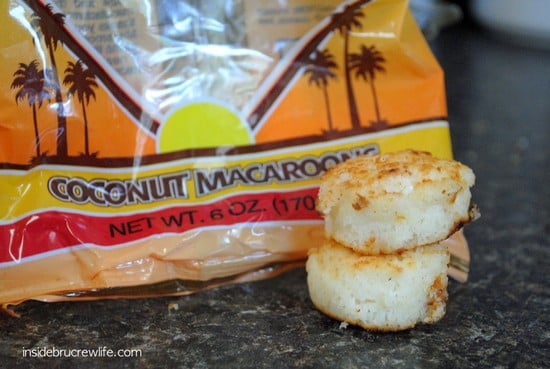 A bag of Coconut Macaroons with 2 of them stacked outside of the bag.
