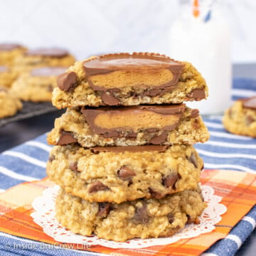 Three oatmeal banana cookies stacked on top of each other with a cookie cut in half showing the full peanut butter cup inside