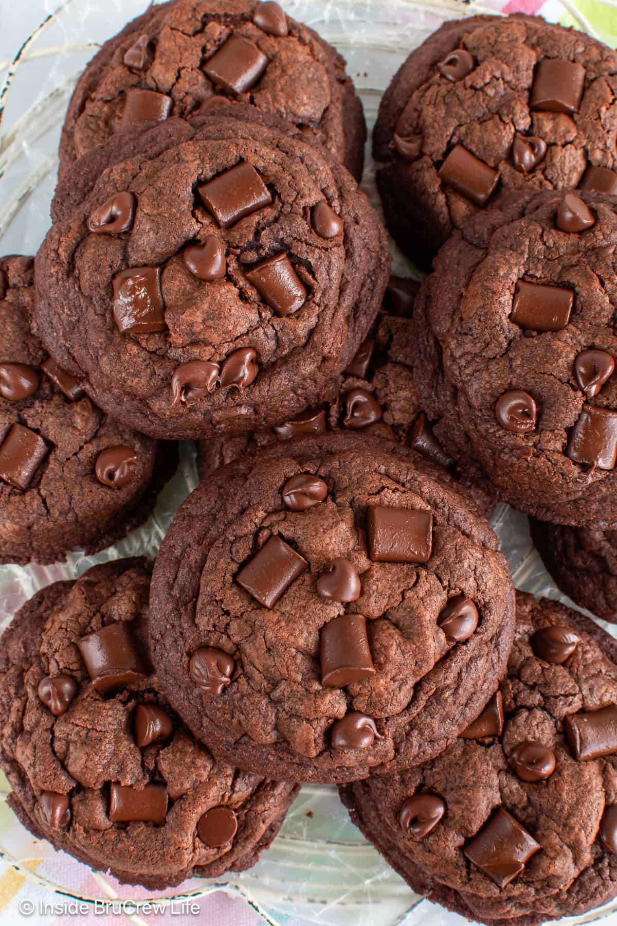 Close up view of a plate of double chocolate chunk cookies.
