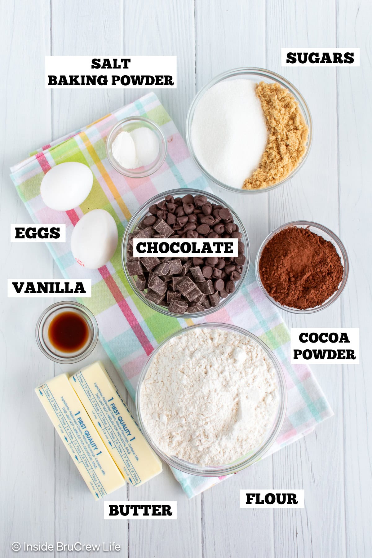 Double chocolate chunk cookies ingredients with text labels overlaying each ingredient.