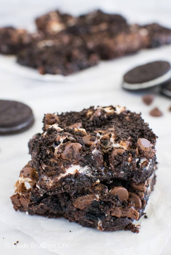 Two gooey brownies stacked on top of each other.