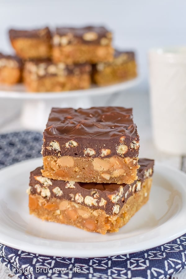 Two homemade Take 5 Bars stacked on top of each other on a white plate