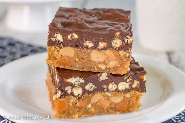 A white plate with two take 5 cookie bars stacked together on it