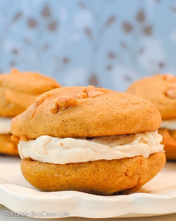 2 Pumpkin butter scotch cookies with salted caramel frosting sandwiched between them.