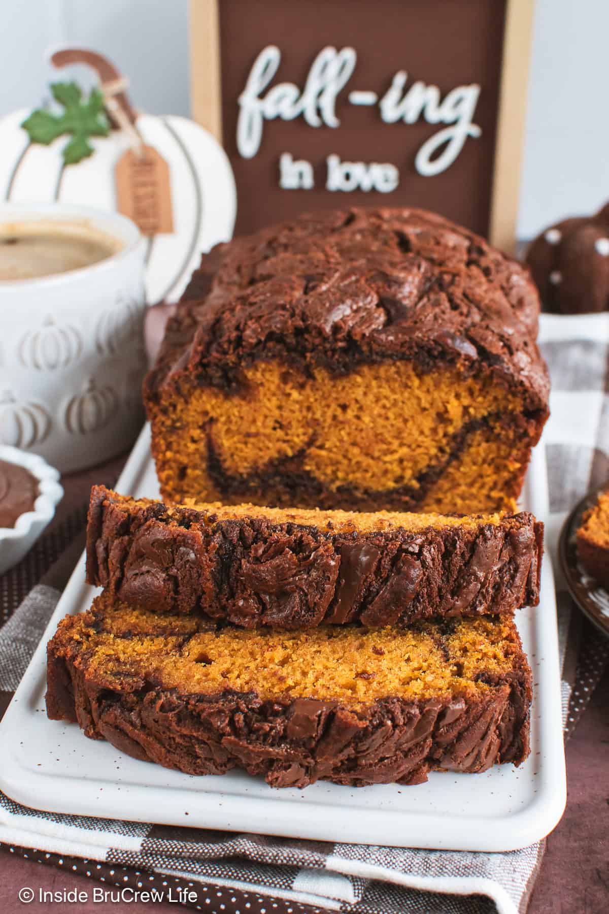 A loaf of Nutella pumpkin bread sliced and on a white tray.