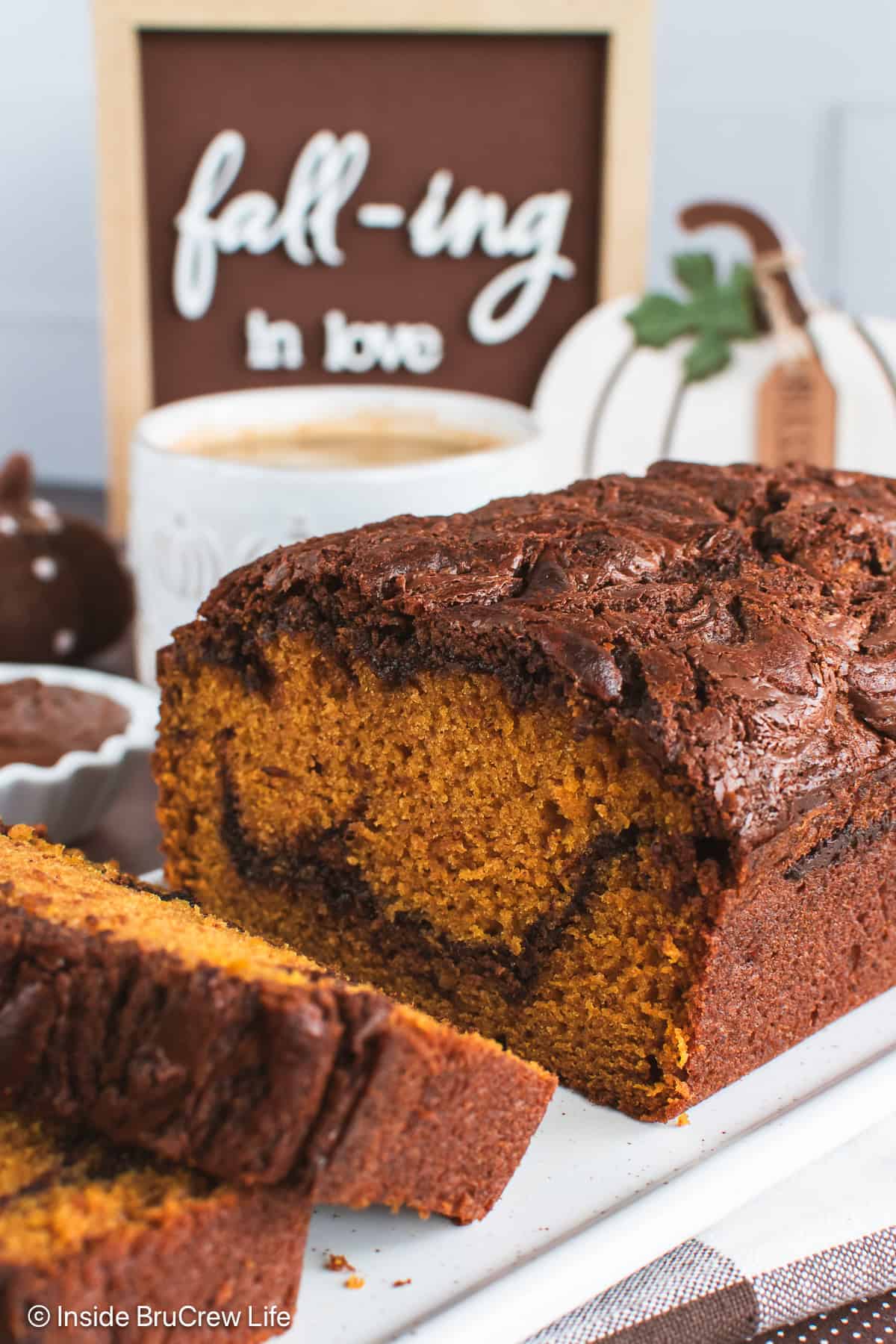 A loaf of pumpkin Nutella bread cut open showing the swirl inside.
