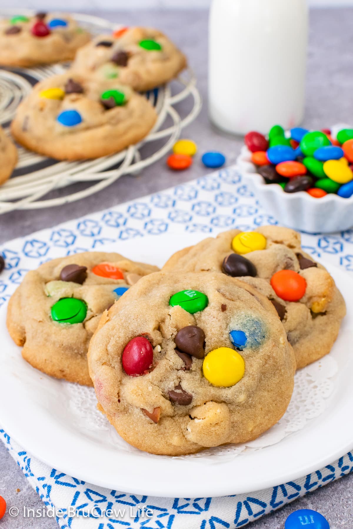 A white plate with three loaded popcorn cookies on it.