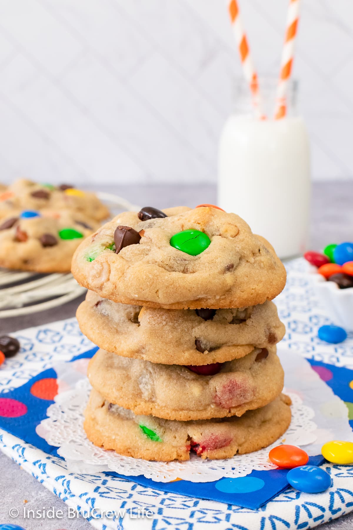 A stack of four peanut butter popcorn cookies on a white plate.