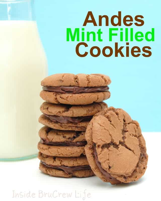 A stack of four Andes Mint Filled Cookies with one leaning beside it and a glass of milk behind them.