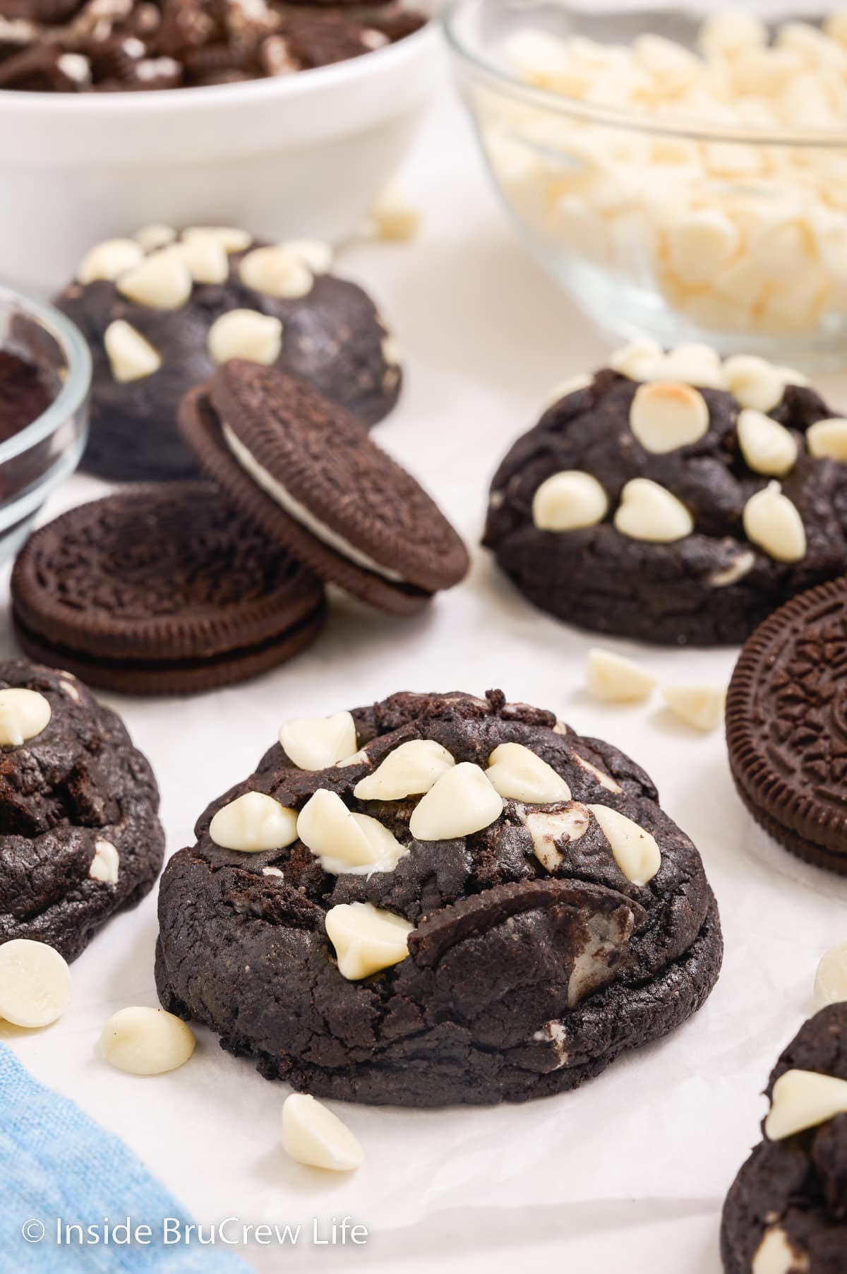Puffy chocolate Oreo cookies on a white paper.