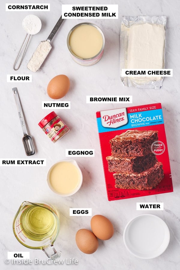 A white board with the ingredients needed to make eggnog brownies on it.