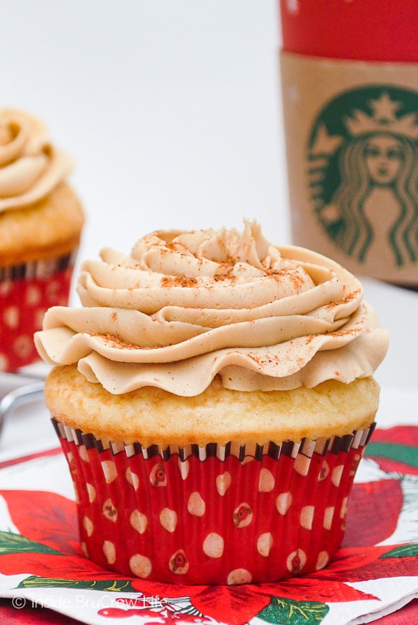 A frosted cupcake in a red liner.