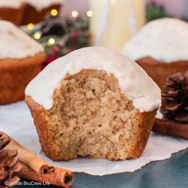 A fluffy glazed muffin on a piece of parchment paper.