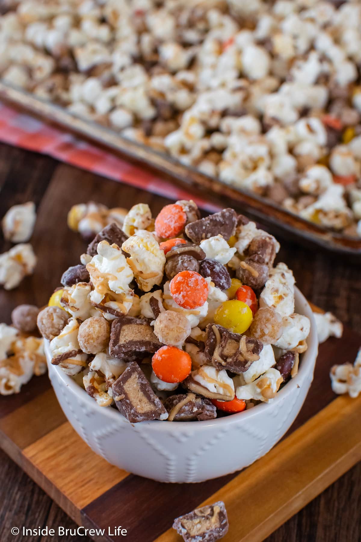 A bowl of candy popcorn on a tray.