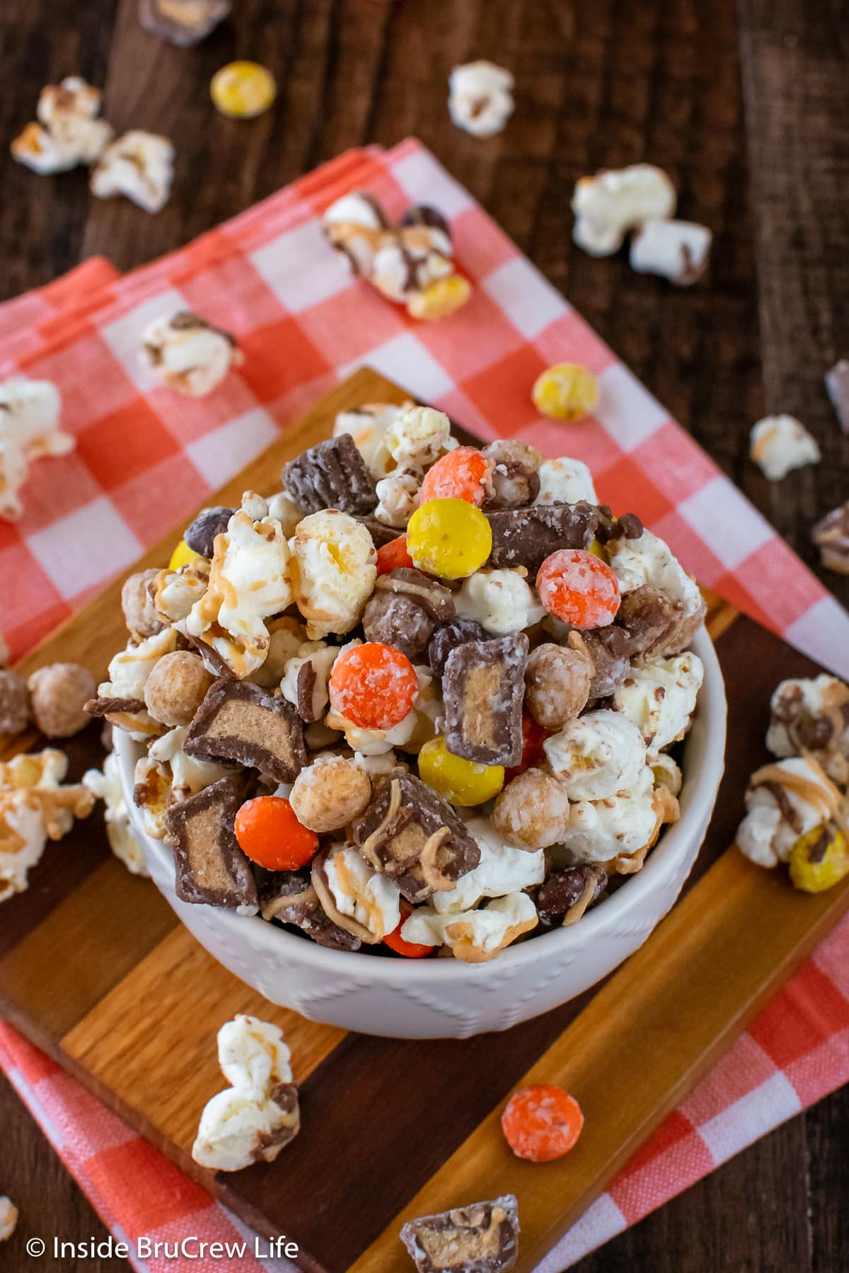 Candy and popcorn in a white bowl.