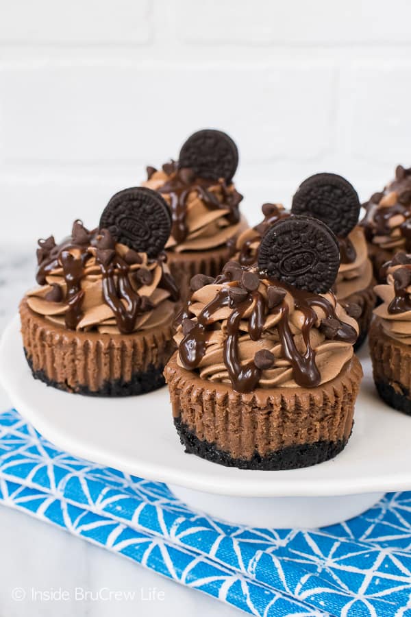 Mini Triple Chocolate Cheesecakes - chocolate in the crust, cheesecake, mousse, and toppings makes these little desserts incredible! Awesome recipe for a chocolate lover! #chocolate #cheesecake #chocolatelovers #Oreocookies #minidesserts #recipe #dessert