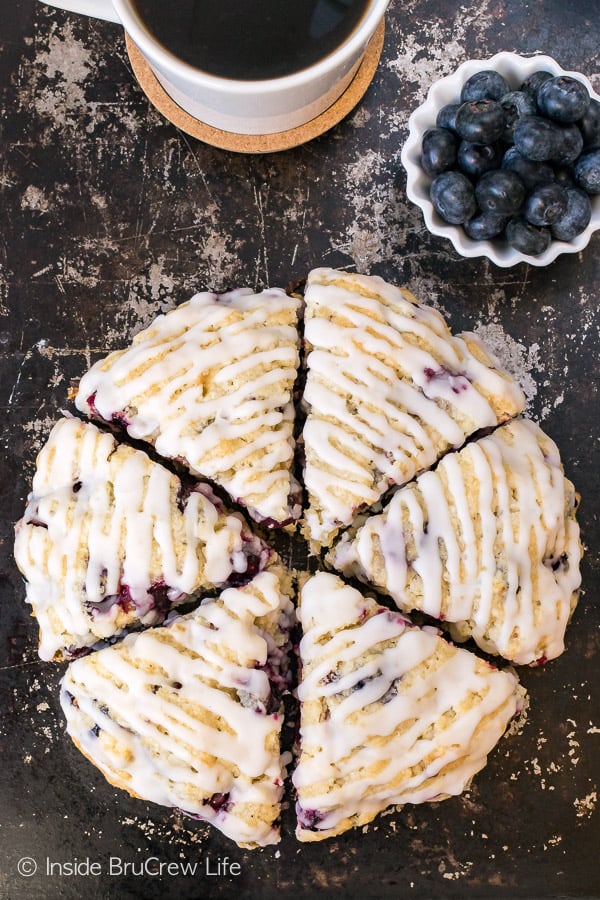 Overhead picture of a sheet pan with coconut scones drizzled with glaze.